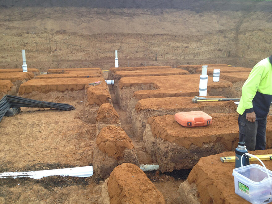 Excavation and pipework before slab Trenches dug with plumbing installed for a new house slab in Melbourne