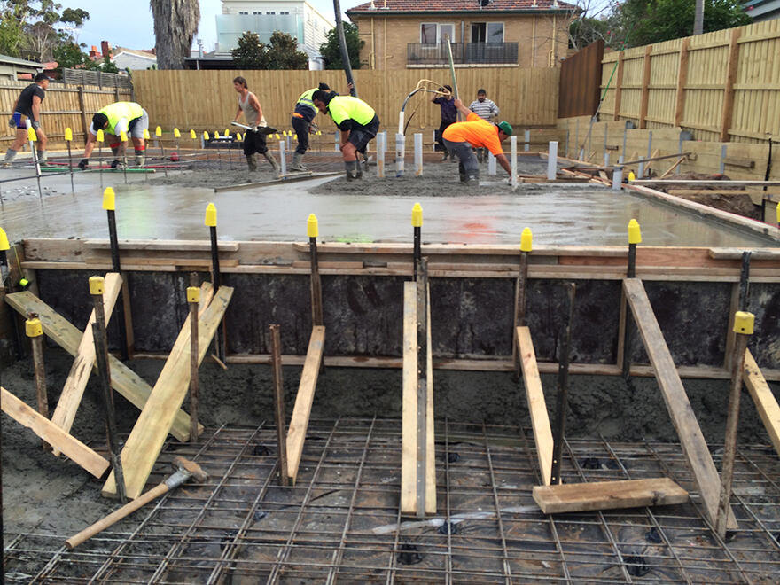 Construction team pouring concrete for a residential house slab in Melbourne